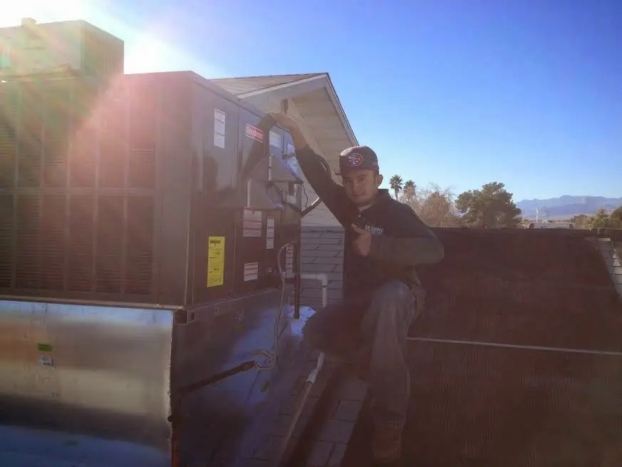 HVAC technician performing HVAC Inspection on a rooftop unit in Pevely
